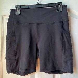 Large black biker shorts. Never worn. Original tag attached. Mesh pockets.
